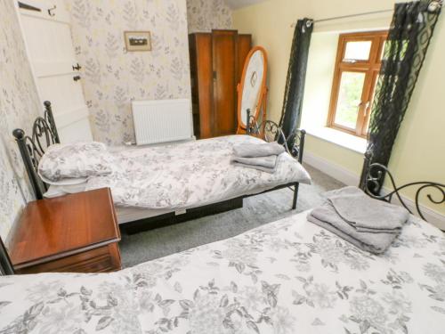 a room with two beds and a window at 3 Tindale Terrace in Brampton
