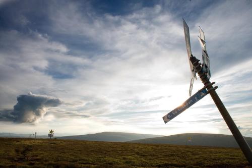 a windmill in a field under a cloudy sky at Gammelgården in  Högfjället