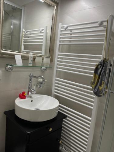 a bathroom with a white sink and a mirror at Hotel Alte Posthalterei in Creuzburg