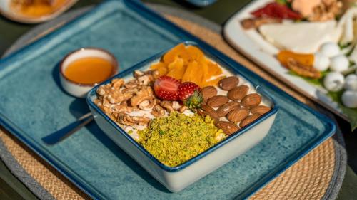 a blue tray of food with nuts and fruit at Vista Del Amor Faralya in Fethiye