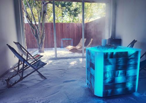a room with a blue table and chairs and a window at Hotel rural Finca Vivaldi Nature & Spa in San Miguel de las Dueñas