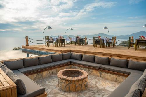a living room with a couch and a table at Vista Del Amor Faralya in Fethiye