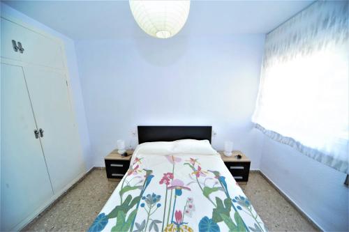 ein kleines Schlafzimmer mit einem Bett und einem Fenster in der Unterkunft LOS DELFINES 6 pax Orange Costa in Benicàssim
