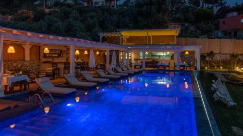 a swimming pool with lounge chairs and a resort at Vista Del Amor Faralya in Fethiye