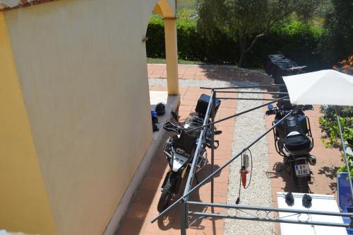 two motorcycles are parked on a balcony at Casa vacanze da Anna in Tortolì