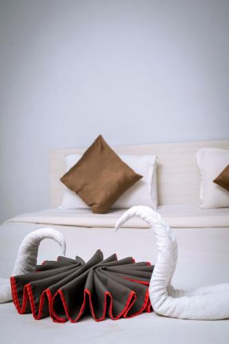 two white and red umbrellas on a bed at GS RESIDENCY in Guwahati
