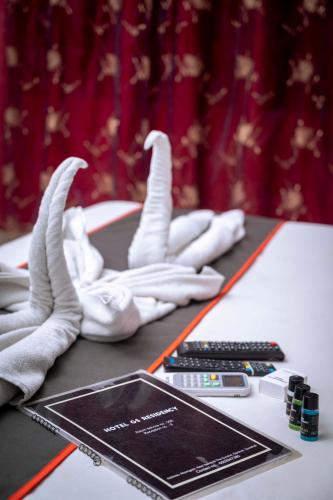 a table with white gloves and a tablet on it at GS RESIDENCY in Guwahati