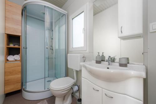 a bathroom with a toilet and a sink and a shower at Guest House Malenica in Sukošan