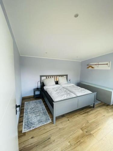 a bedroom with a bed in a white room at Ferienoase Eisvogel in Malchin