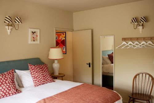 a bedroom with a bed and a mirror at The Queen's Head in Broad Chalke