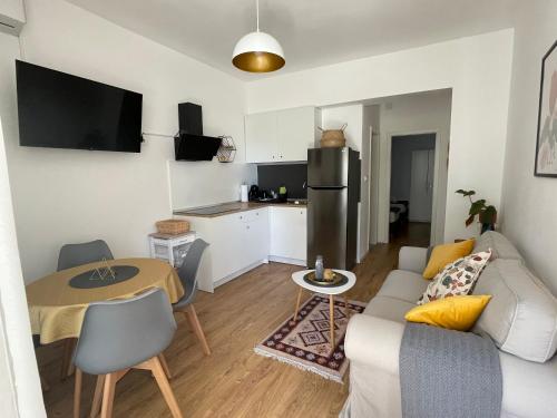 a living room with a couch and a table at Mediterra 1 in Crikvenica