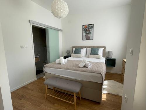a bedroom with a bed and a chair in it at Mediterra 1 in Crikvenica