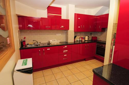 
a kitchen with a sink, stove, and cabinets at Savoy Hostel Galway City Centre in Galway
