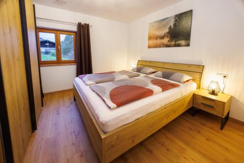 a bedroom with a large wooden bed in a room at Haus Schönblick in Ruhpolding