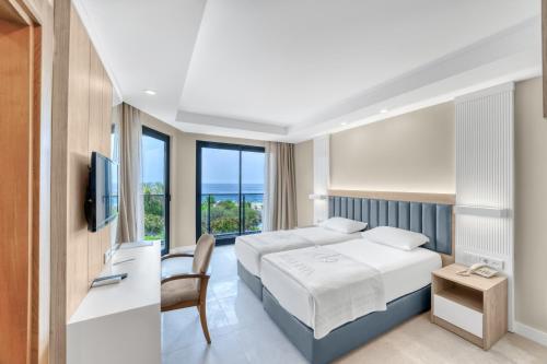 a hotel room with a bed and a television at Kahya Hotel in Alanya