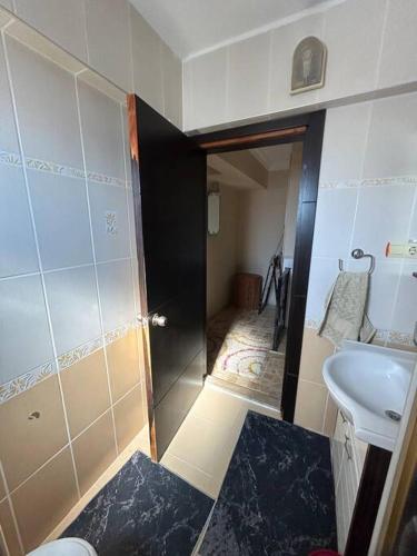 a small bathroom with a sink and a toilet at 2 minute walk to seaside in Kuşadası