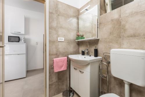 La petite salle de bains est pourvue d'un lavabo et de toilettes. dans l'établissement Apartments Vilma, à Opatija