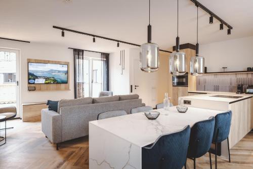 a kitchen and living room with a table and a couch at The Gast House Zell am See in Zell am See