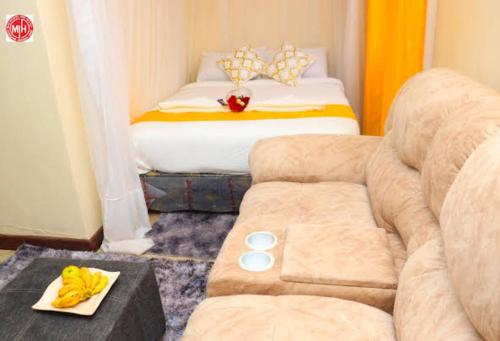a living room with a couch and a bed at Machakos Inn Hotel in Machakos