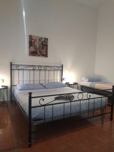 a bedroom with a bed with a metal frame at APPARTAMENTO CENTRO-LAME in Bologna