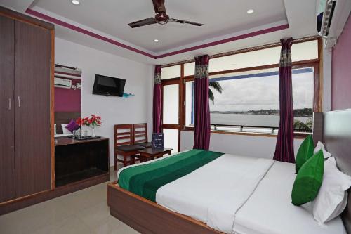 a bedroom with a large bed and a window at OYO Flagship Jazeera Resort in Haddo