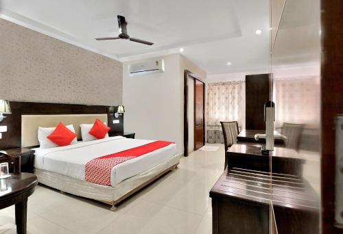 a hotel room with a bed and a desk and a desk at Hotel Rudra Grand Near Kondapur x Road in Kondapur
