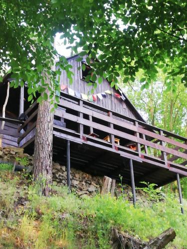 a wooden bridge sitting next to a tree at Chatrč pod Babou in Křivoklát