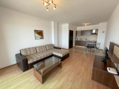 a living room with a couch and a table at Menada Rocamar Apartments in Tsarevo