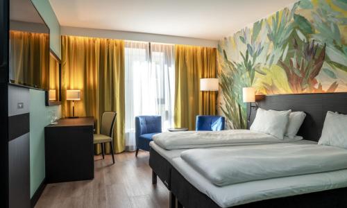 a hotel room with a bed and a painting on the wall at Thon Hotel Ålesund in Ålesund