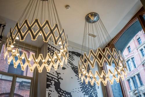 two chandeliers hanging from the ceiling in a room at The Townhouse Manchester in Manchester