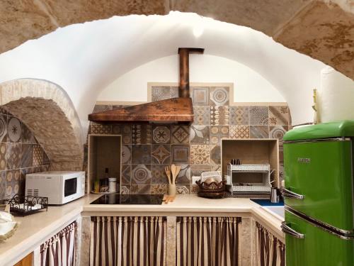 a kitchen with a stove top oven in a room at TRULLI DI ZIA TATA in Locorotondo