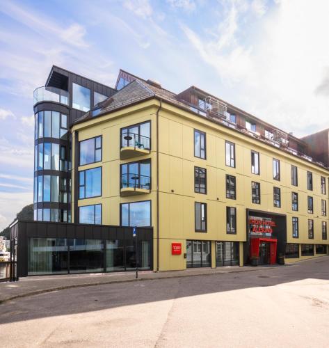 a large yellow building with a glass at Thon Hotel Ålesund in Ålesund