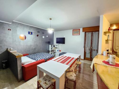 a living room with a red couch and a bed at BIKE HOUSE "evo" in Seriate