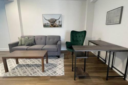 a living room with a couch and a table at Bay Motel in North Bay