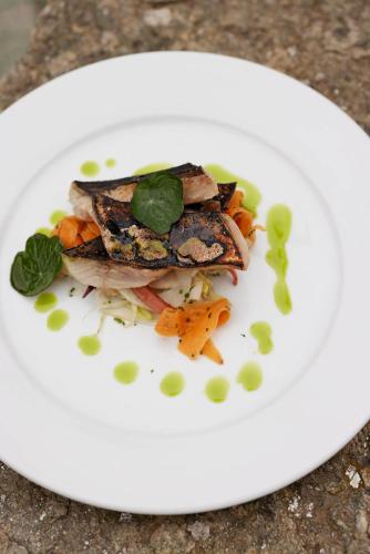 a white plate with a piece of food on it at The Queen's Head in Broad Chalke