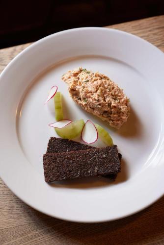 a white plate with two pieces of food on it at The Queen's Head in Broad Chalke