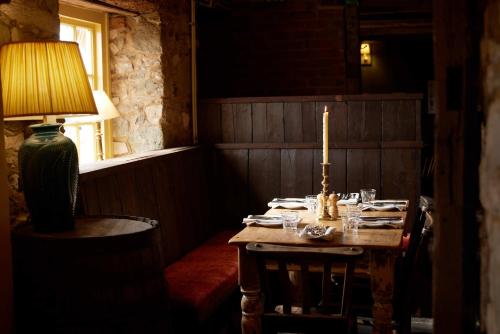a table with a candle on it in a room at The Queen's Head in Broad Chalke