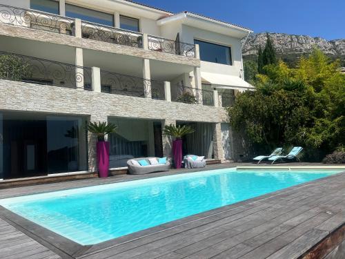 a swimming pool in front of a building at Luxurious studio suite near Monaco with sea view in Éze