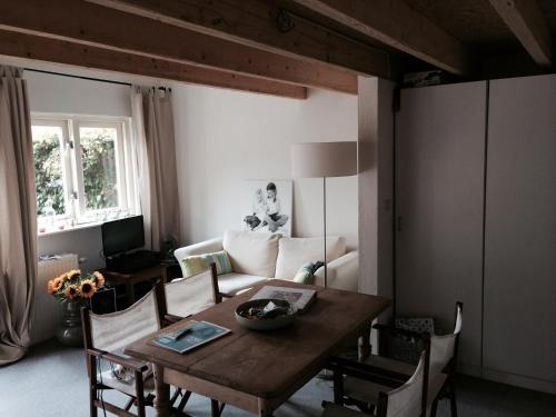 a living room with a table and a couch at Almost At The Beach in Wijk aan Zee