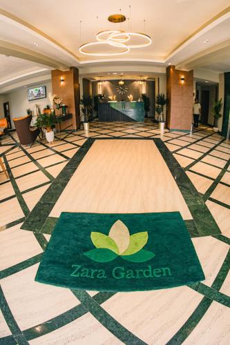 a lobby with a zero garden sign on the floor at Zara Garden Hotel and Apartments in Kampala