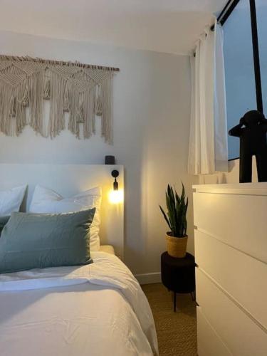 a bedroom with a bed with a dresser and a window at Gites du réservoir in Mauguio