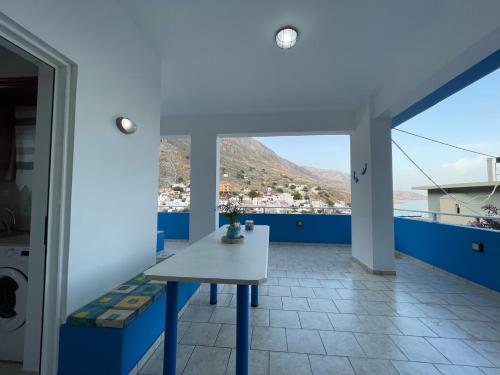 a balcony with a table and a view of a city at Mediterranean Dolphin Guest House in Paránimfoi