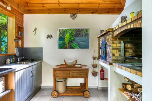 a kitchen with a sink and a stove at La Case O zoizos in Saint-Joseph