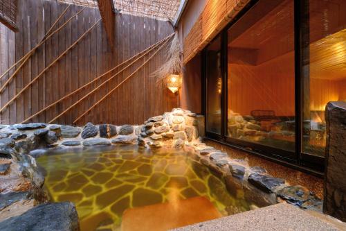 a hot tub in the middle of a house at Dormy Inn Sendai Annex in Sendai