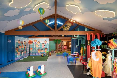 a childrens play area with a ceiling with clouds at Hotel Fazenda Vilarejo All Inclusive in Conservatória