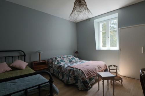 a bedroom with two beds and a window at Le Gentiane - Villa Chanterive in La Bourboule