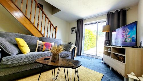 a living room with a couch and a tv at Modern 2-Bed House in Stoke Gifford, NR Parkway Statn, Free Parking in Bristol
