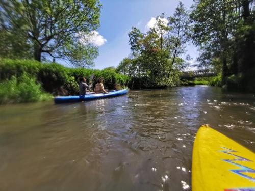 two people in a canoe on a river at Grande maison détente & loisirs in Sargé-sur-Braye