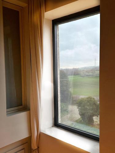 a window with a view of a field at La casa di Zoe-ARTANDTRAVEL in Montefiascone