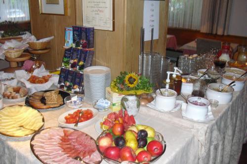 a table topped with plates of food and fruit at Dependance Villnerhof in Egna